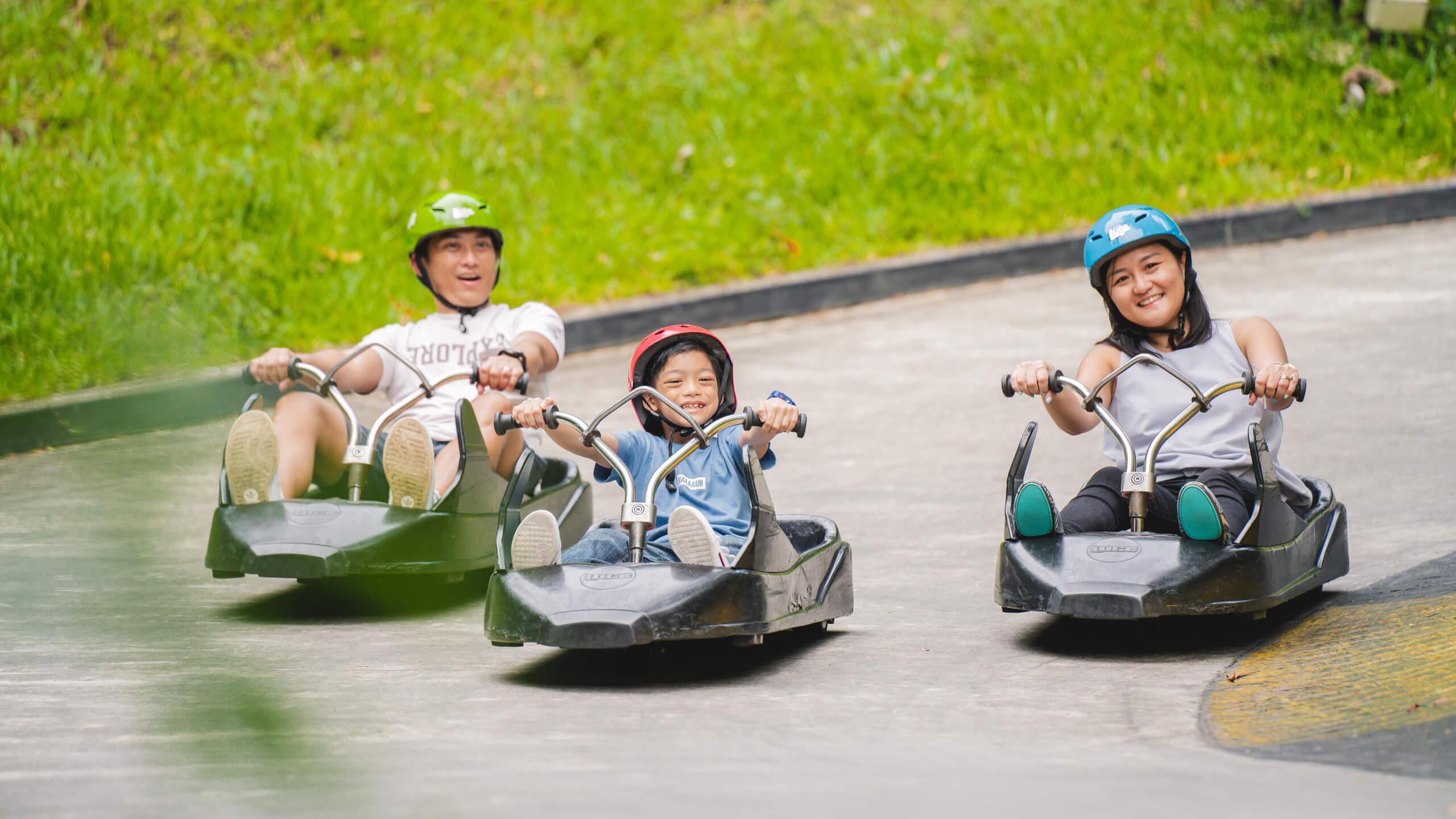 A family rides down the Luge together.