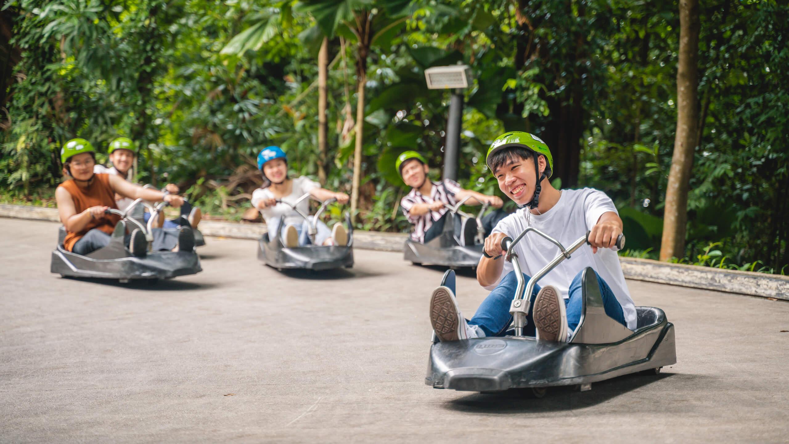 Friends race each other down the Luge tracks in Singapore.