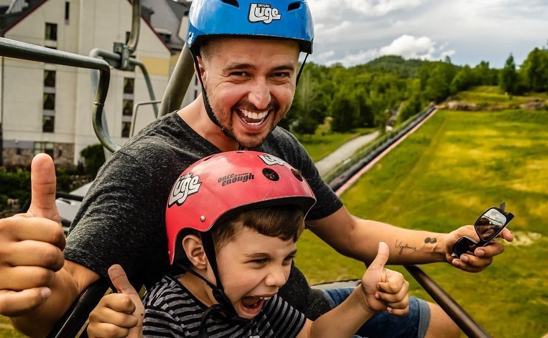 A father and son excited on the chairlift ready to ride the Luge.